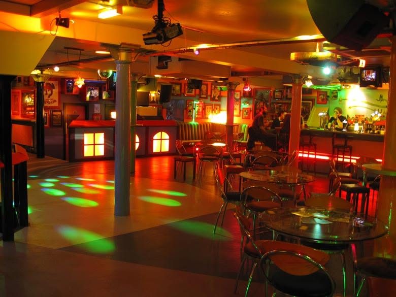 The basement bar with its dancefloor, pillars and TV screens