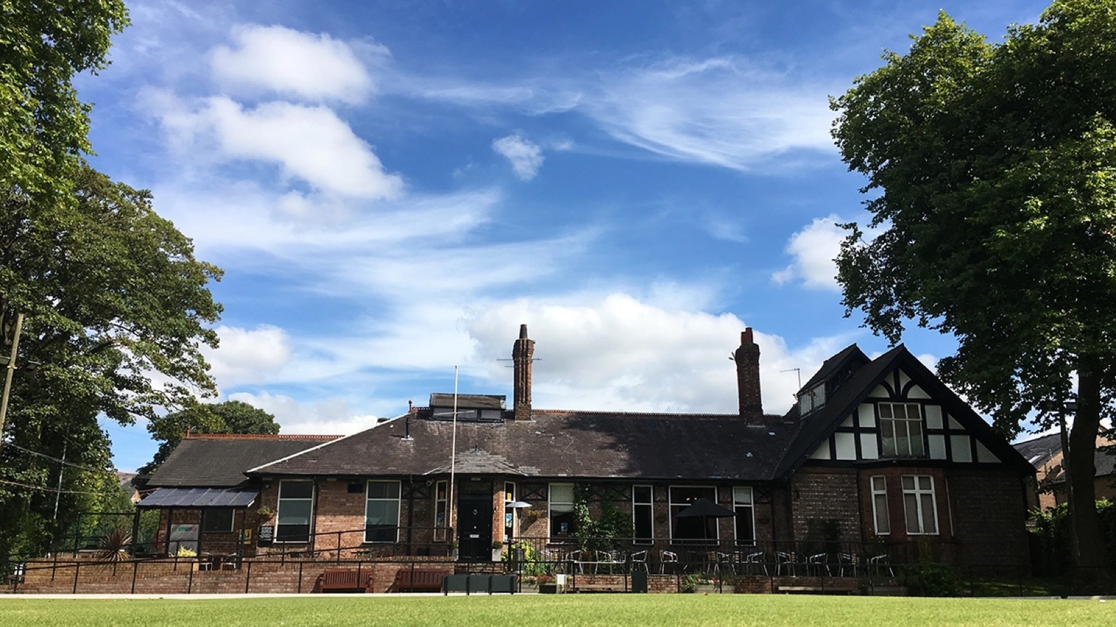 The Albert Club clubhouse across the bowling green on a sunny day
